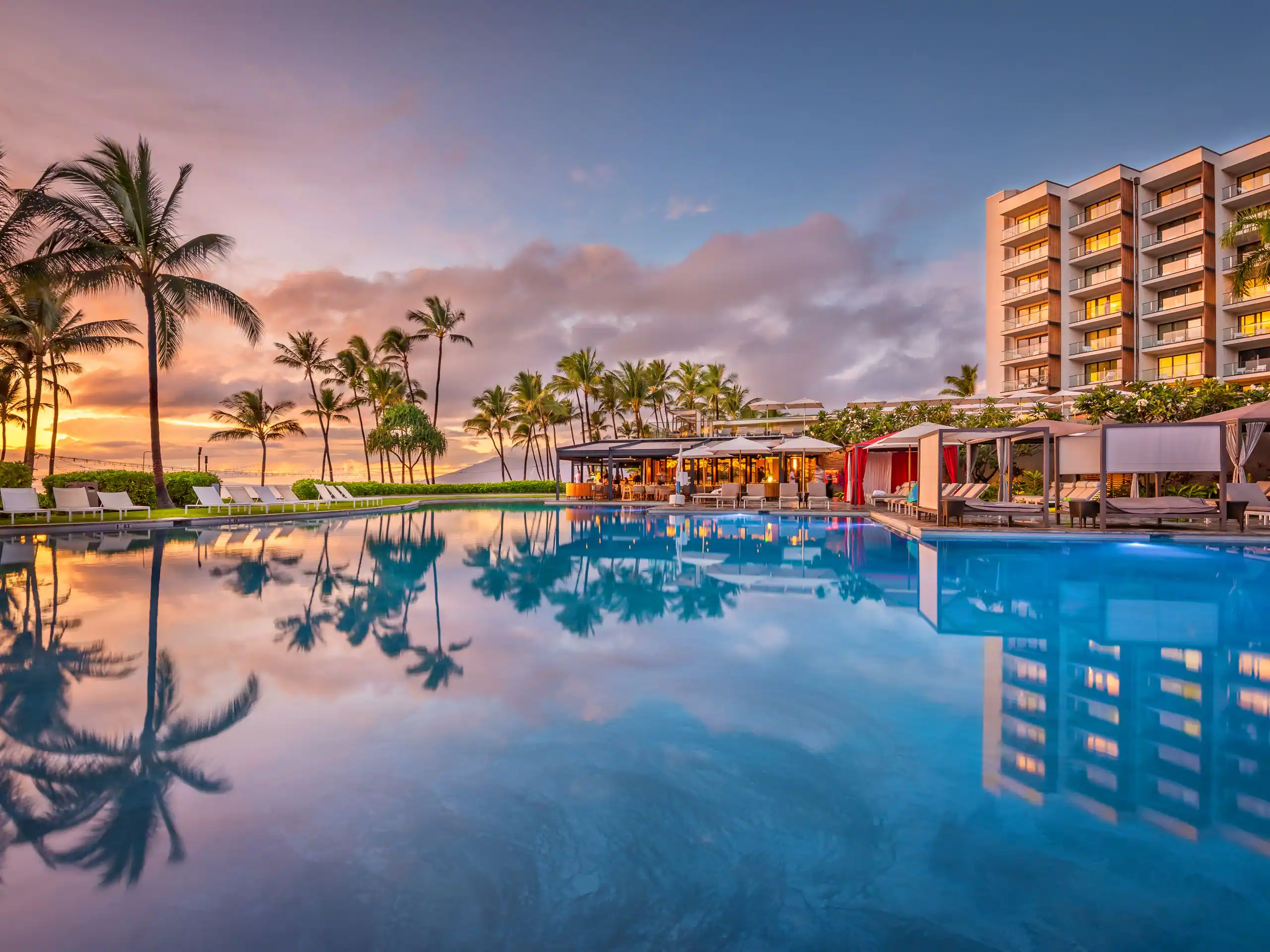 Bumbye Pool at Andaz Maui at sunset with palm trees and ocean view
